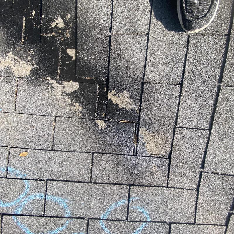 Asphalt shingle roof with damaged and missing granules Asphalt shingle roof with damaged and missing granules