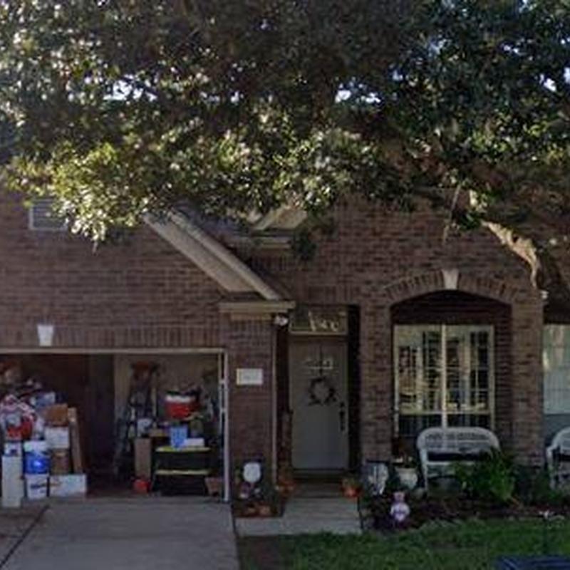 Residential roof with tree shading and open garage