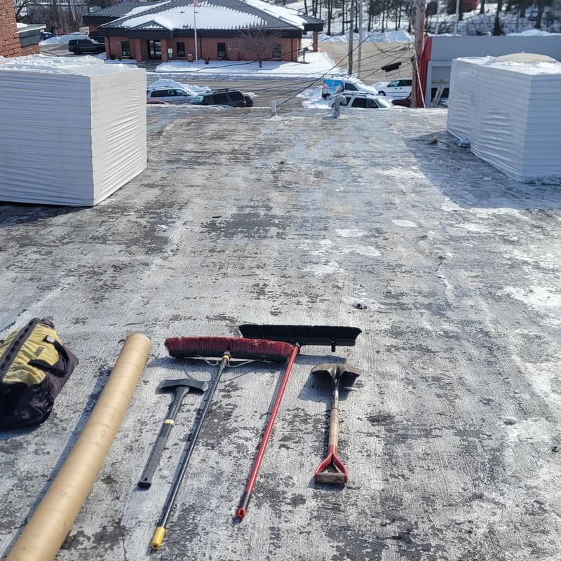PVC single ply roofing surface with tools laid out