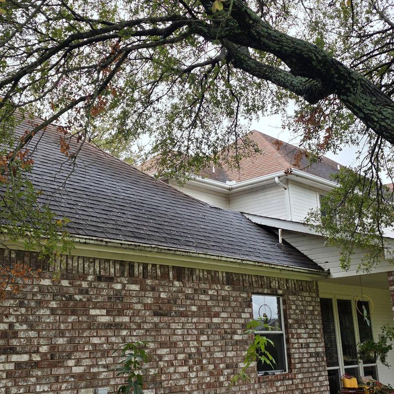 Asphalt shingle roof with hail damage on residential home