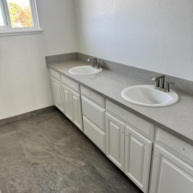 Bathroom sinks with new faucets and countertop installation