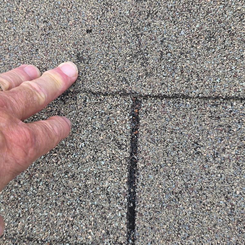 Asphalt roof shingle gap causing potential leak
