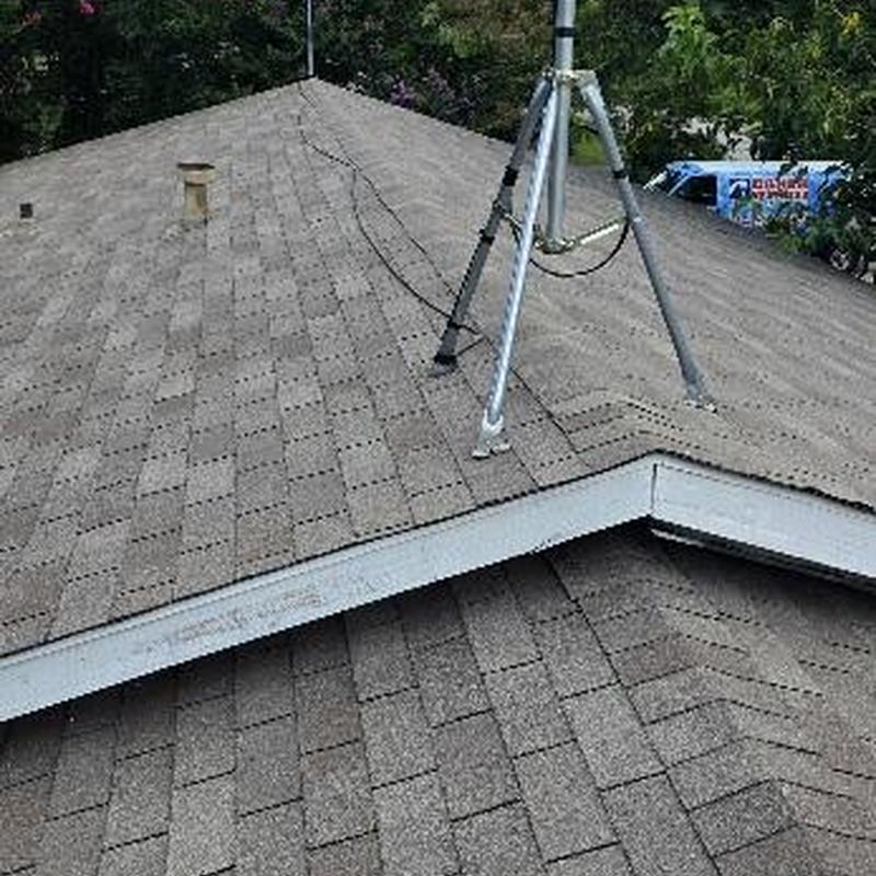 Asphalt shingle roof with antenna mount and vent pipe