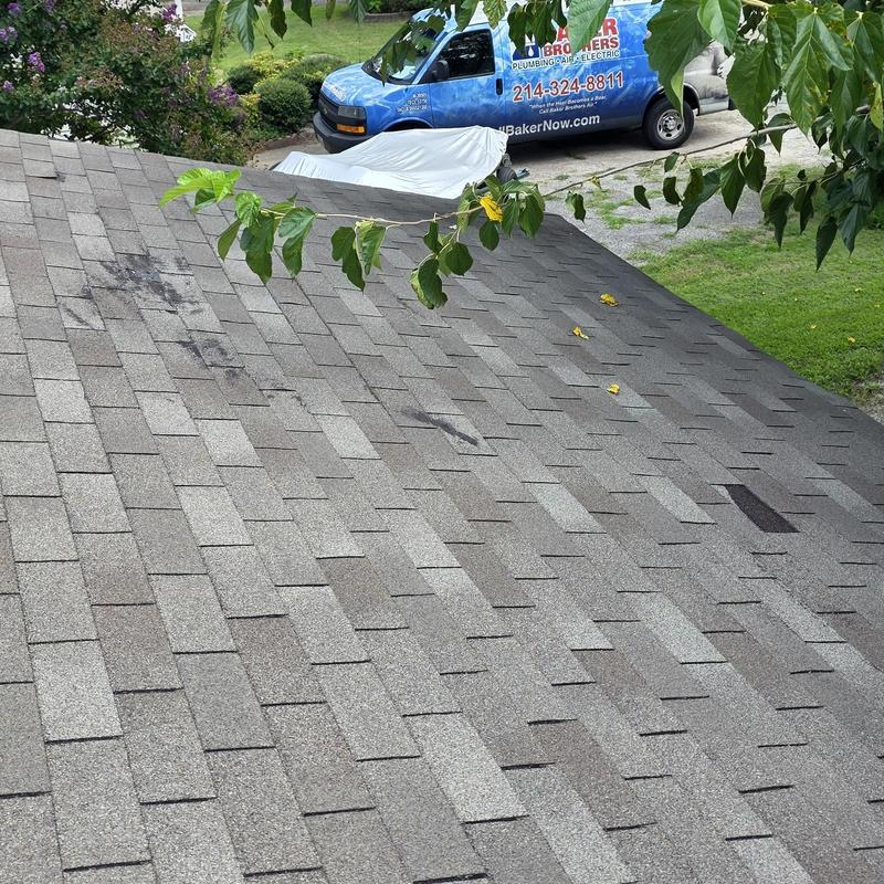 Roof shingles with black ice dam damage marks