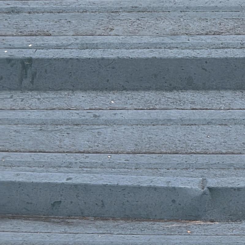 Metal roof panels with visible rust spots and damage