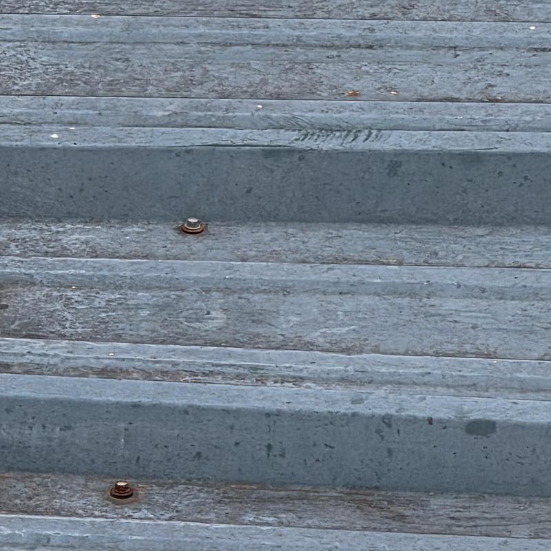 Metal roof panels with rusted fasteners causing leaks