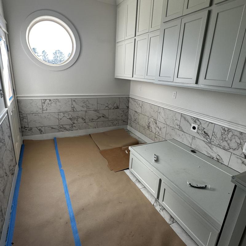 Marble wall tile installation with cabinetry in new room Marble wall tile installation with cabinetry in new room