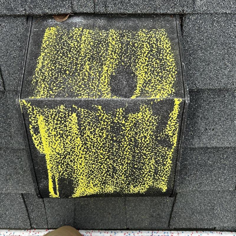 Roof vent with hail damage marked in yellow paint