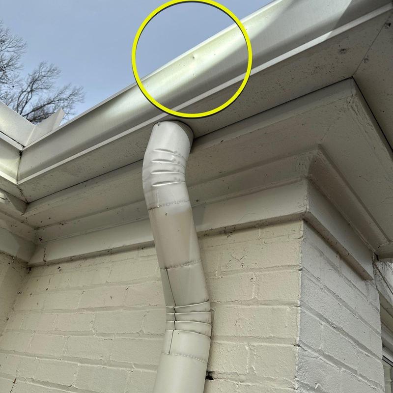 Gutter system with hail damage highlighted in yellow