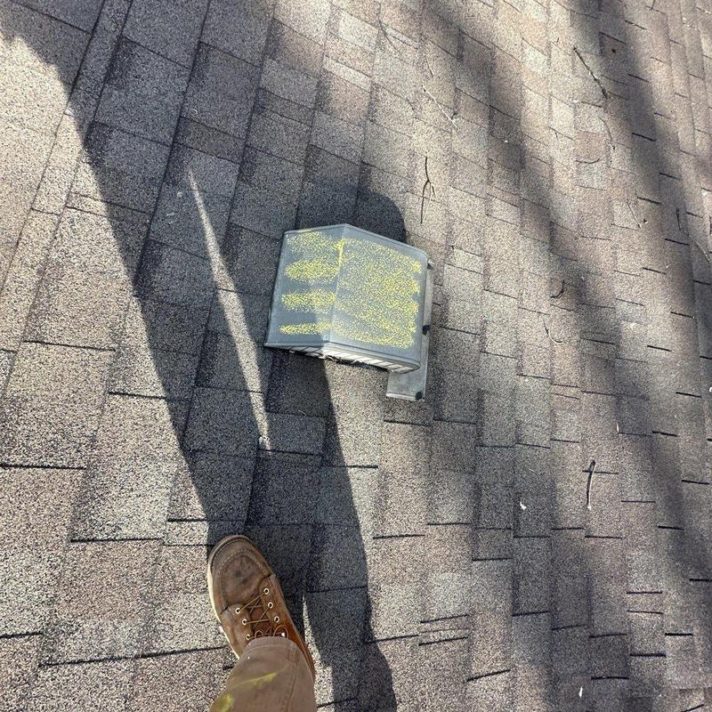 Roof vent with hail damage on asphalt shingles