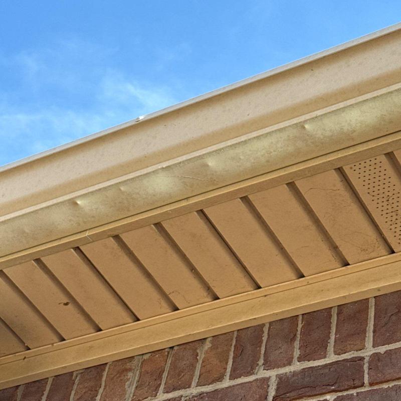 Fascia and soffit panels inspection on brick roof edge