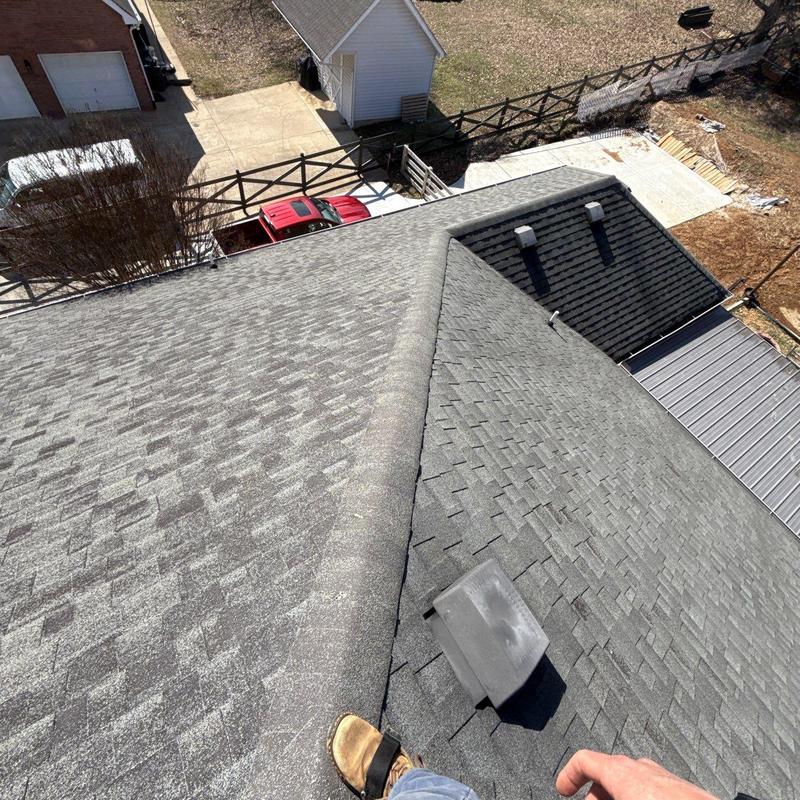 Asphalt shingle roof with ridge cap and vent inspection