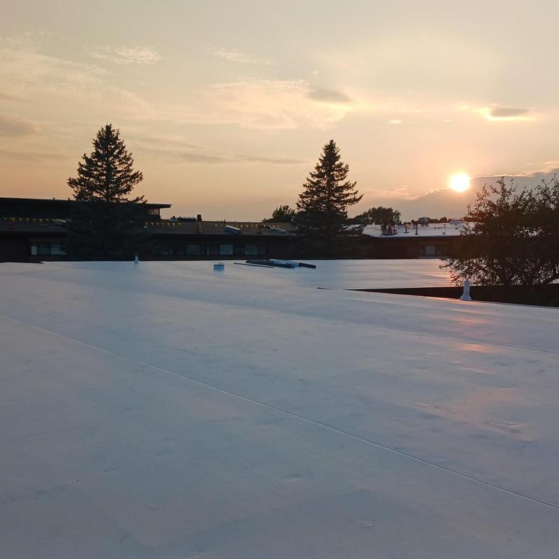 TPO roofing system on commercial building at sunset TPO roofing system on commercial building at sunset