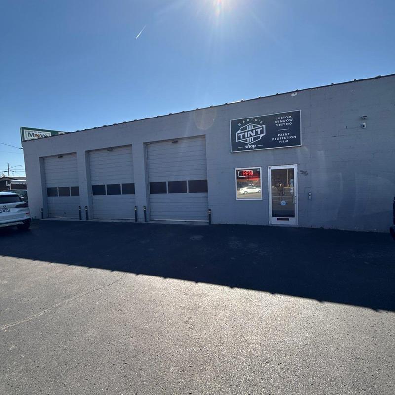 Window tint shop exterior with garage doors