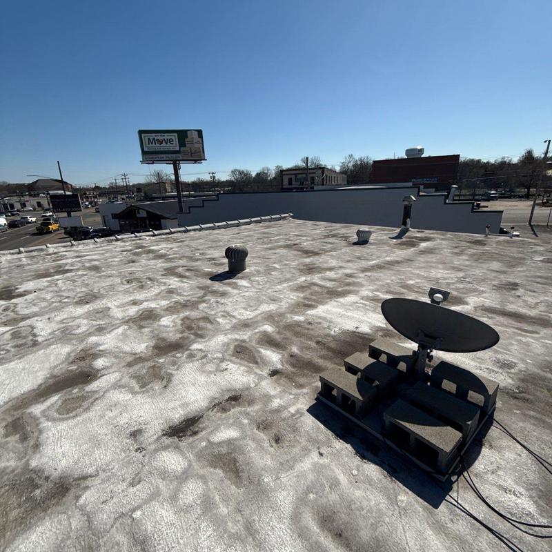 Flat roof membrane with vents and satellite dish