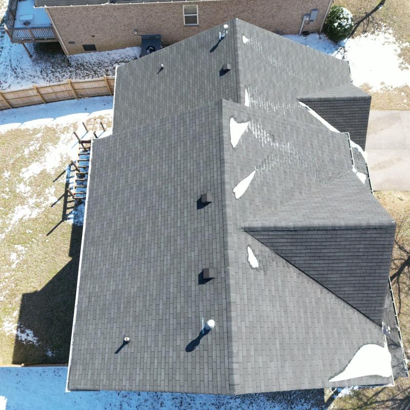 Asphalt shingle roof with hail damage patches