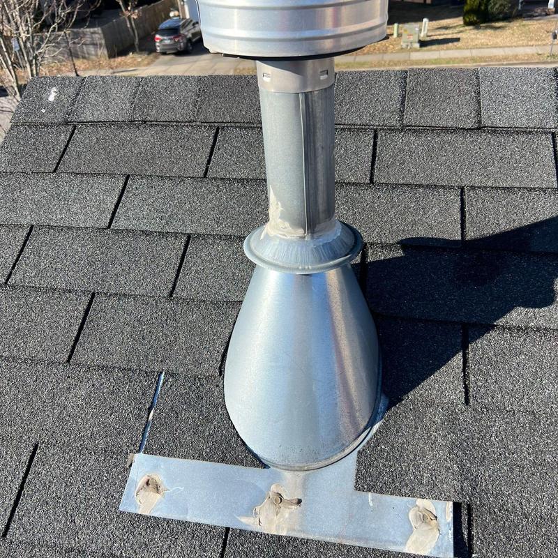 Metal pipe flashing on asphalt shingle roof inspection