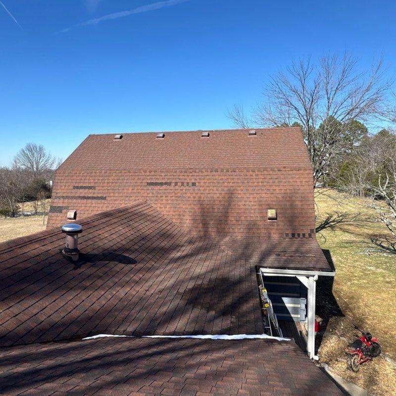 Roof shingles with hail damage and ventilation vents