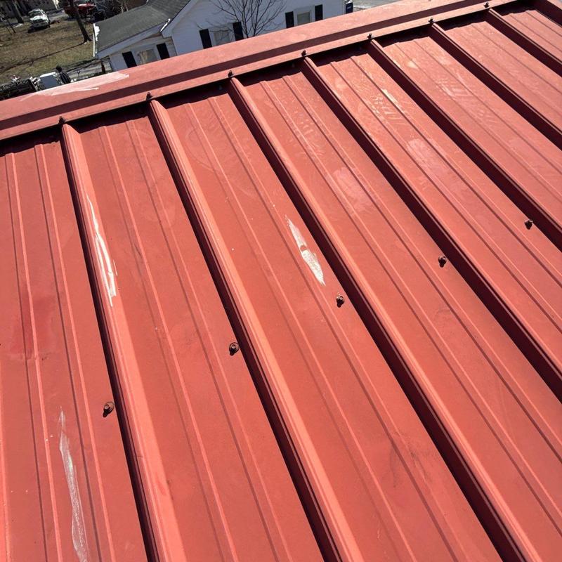 Metal roof panels with visible hail damage spots
