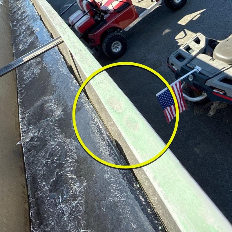 Metal roof flashing with hail damage on commercial roof