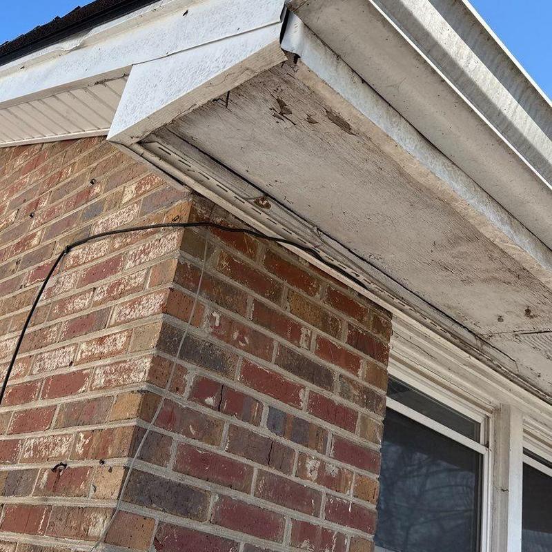 Soffit and fascia board with water damage and wear