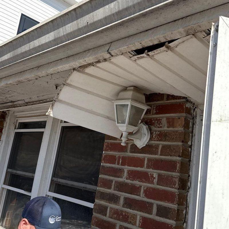 Metal soffit panel damage and outdoor light fixture