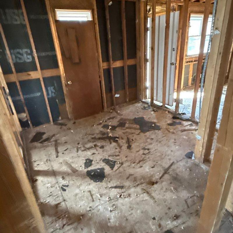 Subfloor demolition and debris removal in interior room