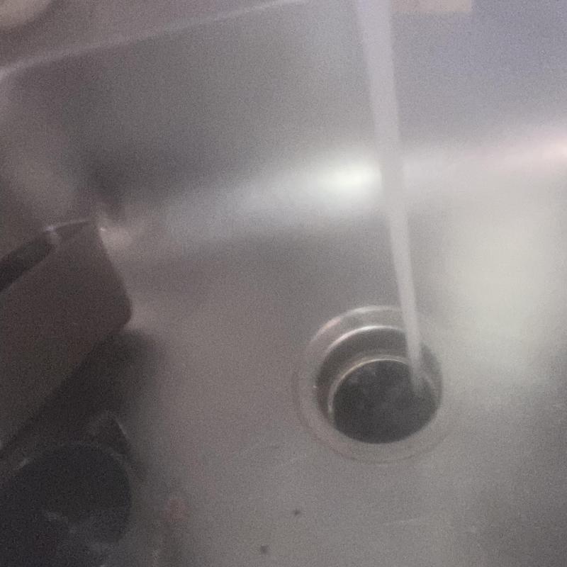 Garbage disposal drain with running water in stainless sink
