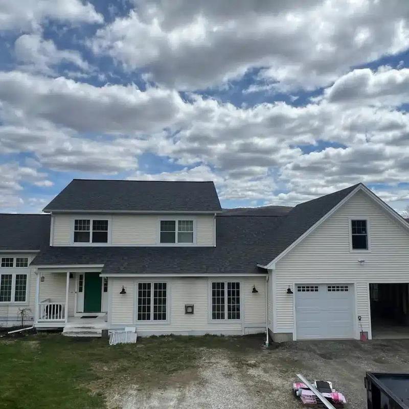 Residential shingle roof on white Vermont home