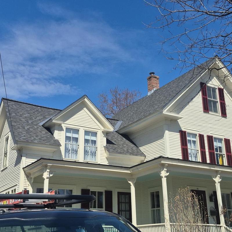Asphalt shingle residential roof with clear blue sky