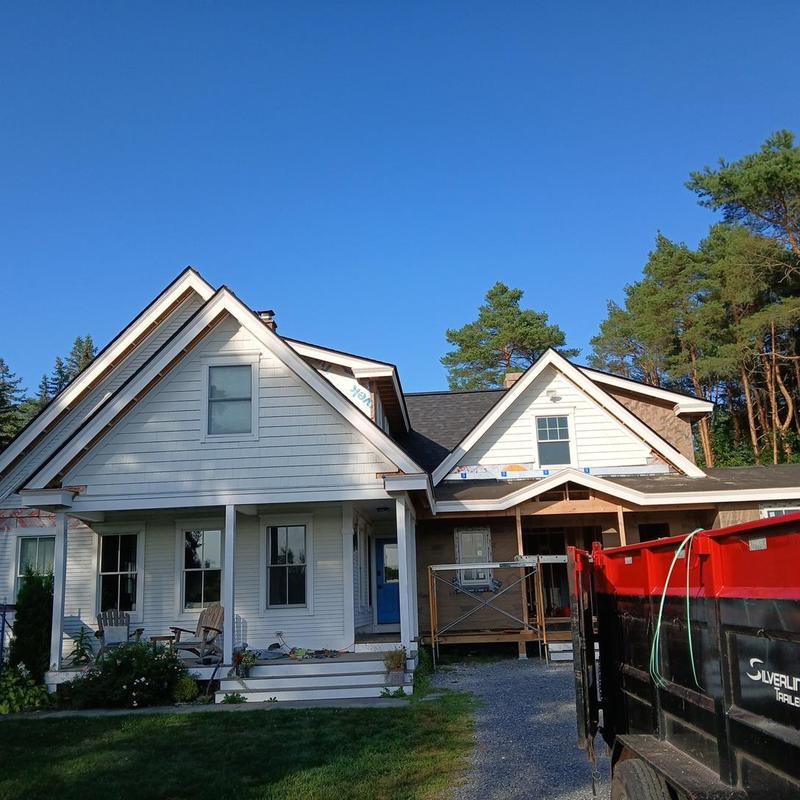 Hybrid roof with asphalt shingles and metal panels