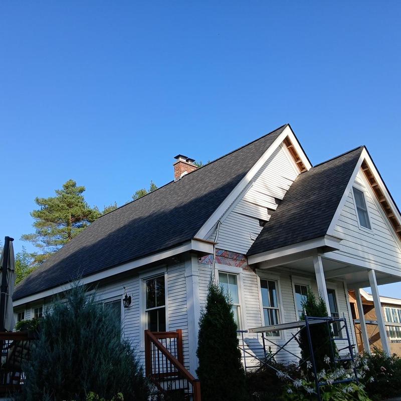 Hybrid asphalt shingle and standing seam metal roof