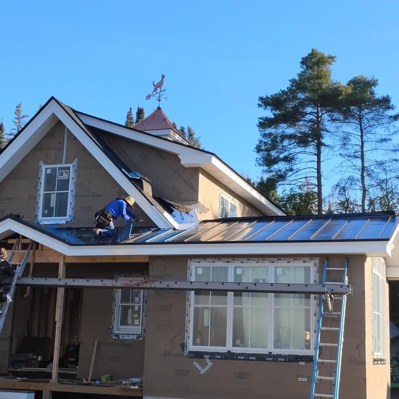 Standing seam metal roof installation on house in Vermont