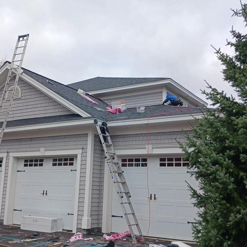 Asphalt shingle roof installation on residential garage
