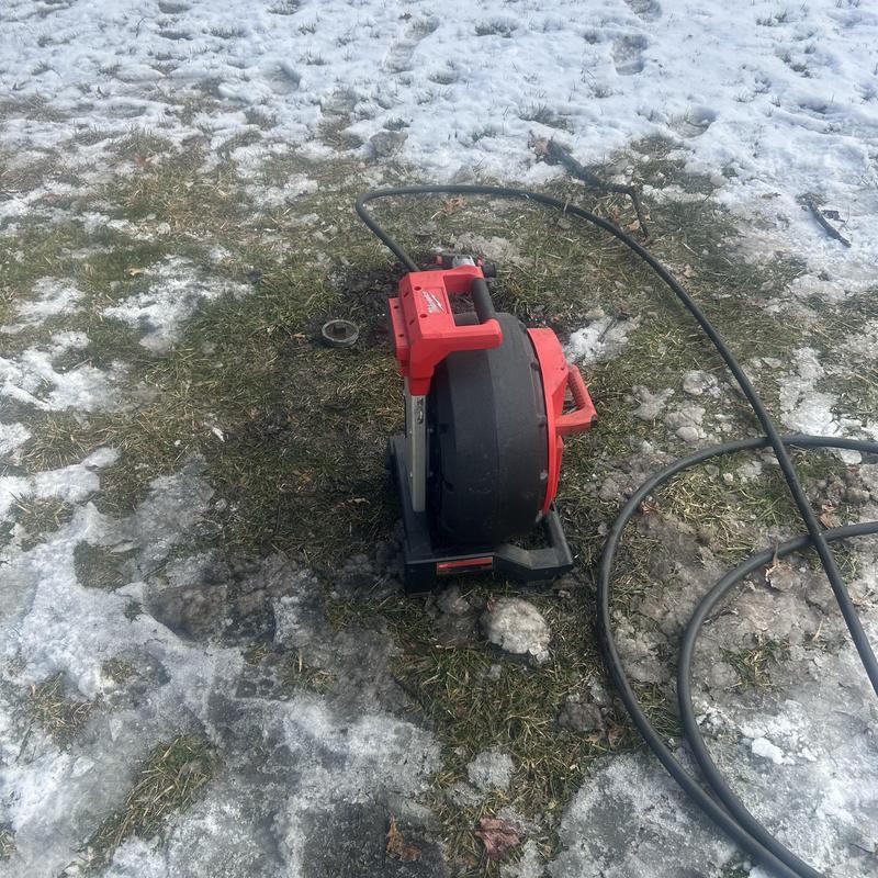 Sewer pipe camera inspection machine on snowy grass