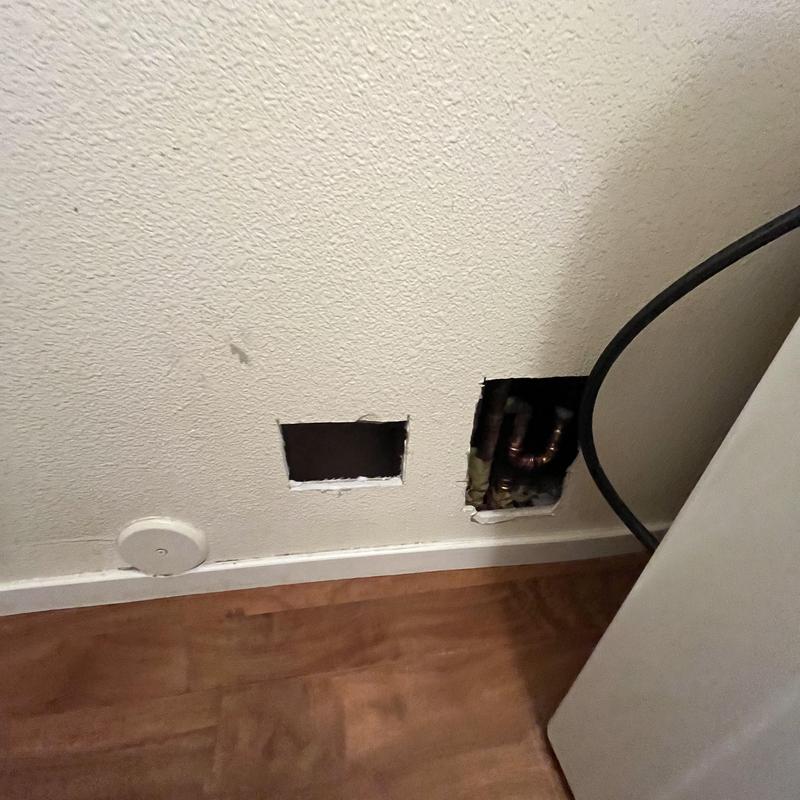 Hot water main pipes exposed in wall cutouts