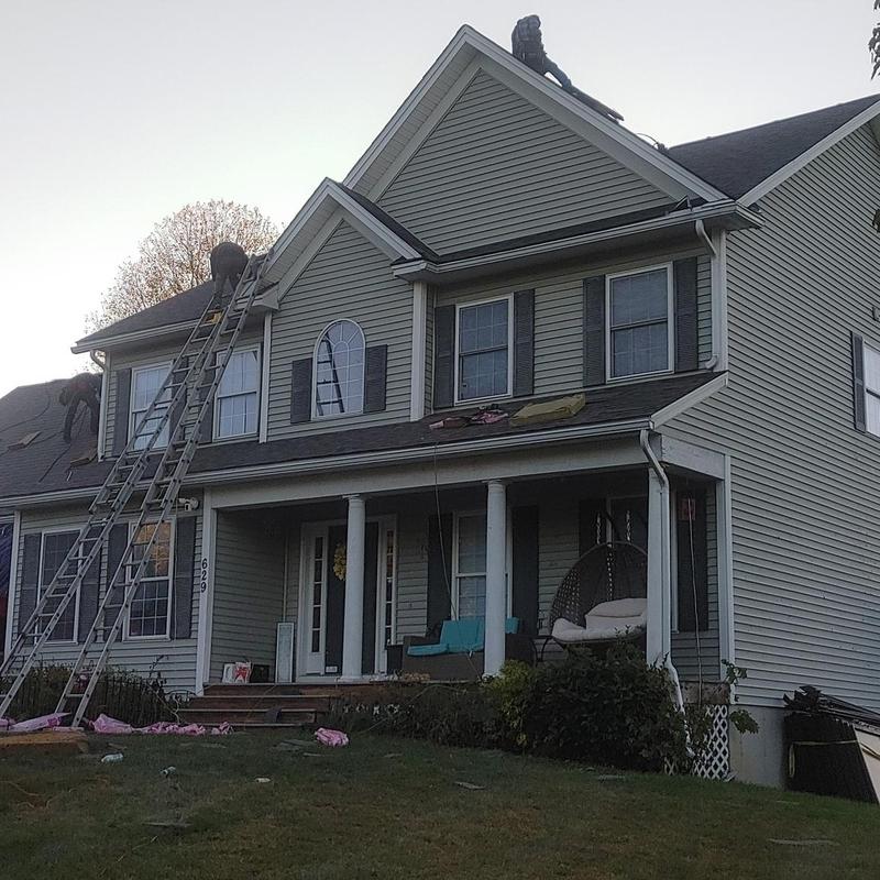 Architectural asphalt shingle roof installation on house