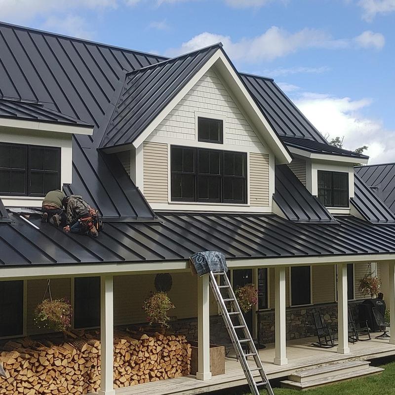 Standing seam metal roof installation on home exterior