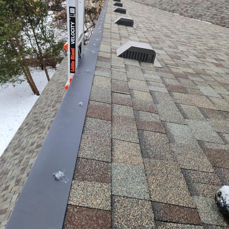 Asphalt shingle roof with new metal drip edge installed