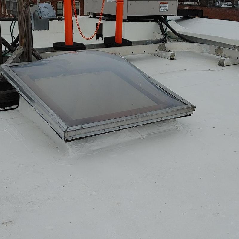 Skylight on flat TPO roof with sealed edges