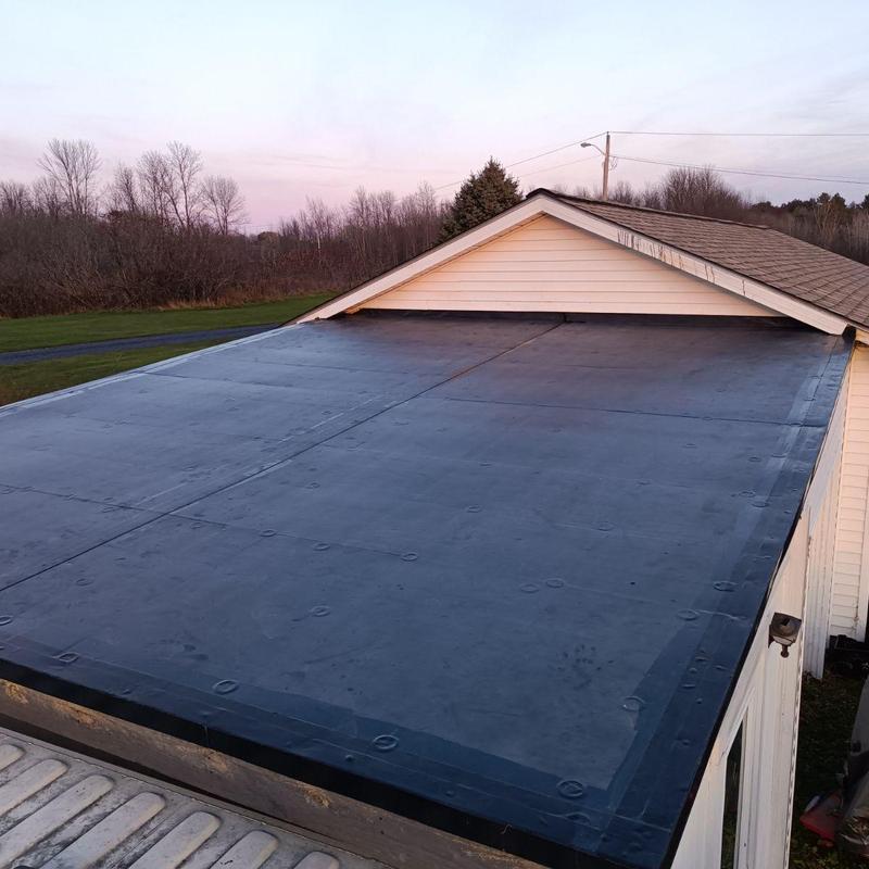 EPDM flat roof membrane installation on residential garage