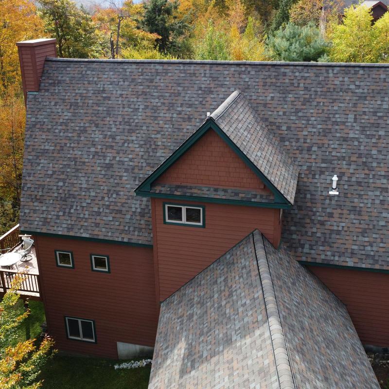 Asphalt shingle roof on mountain home in fall