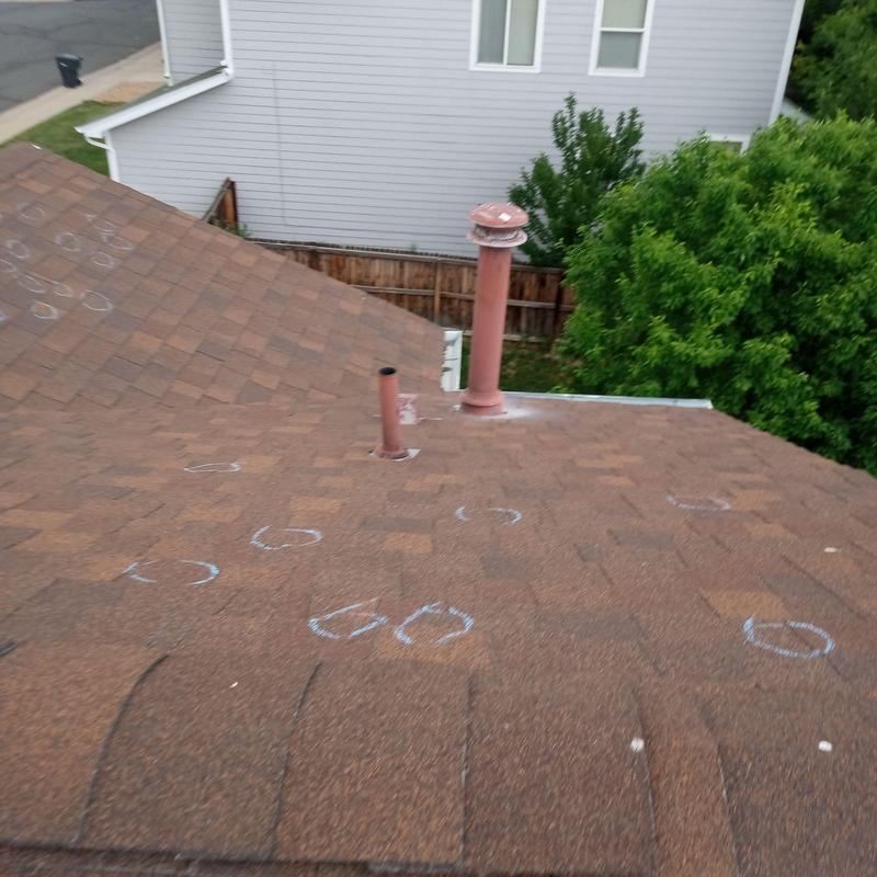 Asphalt shingle roof with hail damage marked for repair Asphalt shingle roof with hail damage marked for repair
