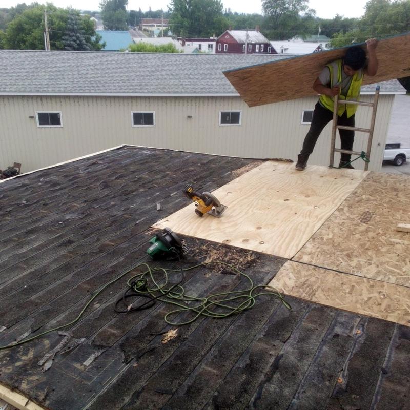 Plywood roof deck replacement with power tools and worker Plywood roof deck replacement with power tools and worker
