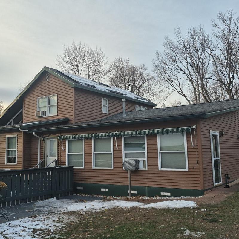 Shingle roof on residential home in winter setting