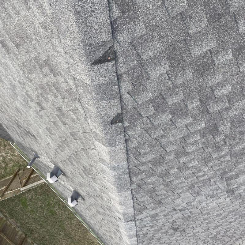 Architectural asphalt shingles with damaged ridge caps