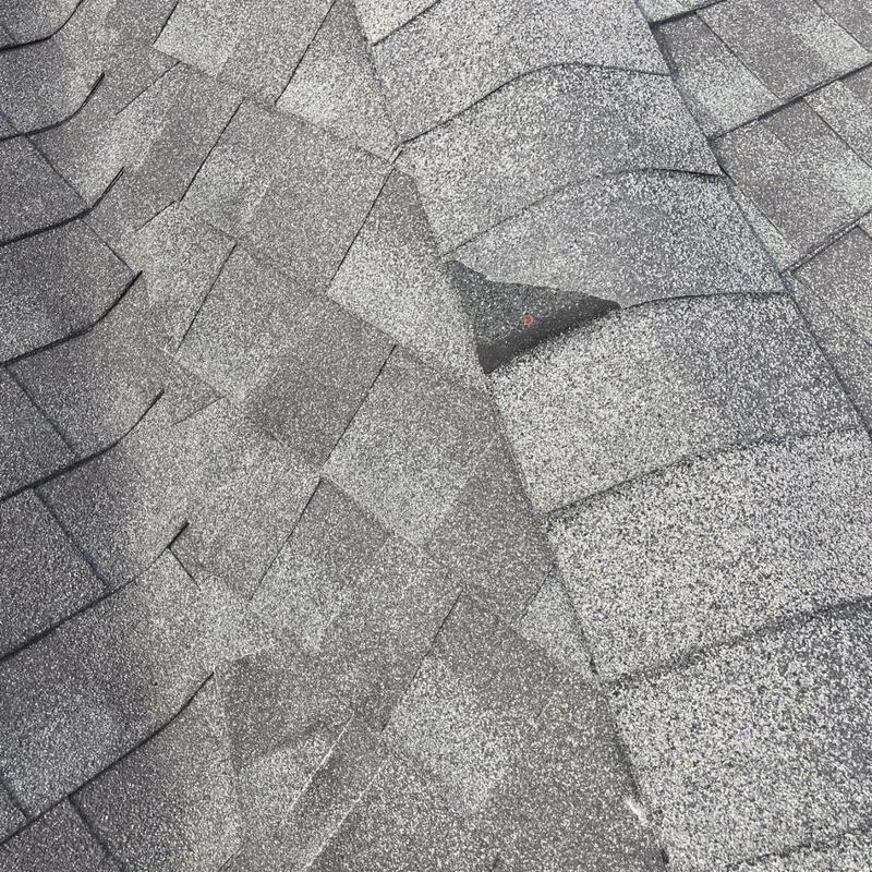 Architectural asphalt shingles with lifted tab and nail exposed