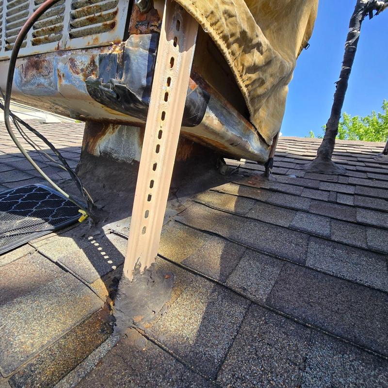 Rusted swamp cooler on shingled roof with flashing issues Rusted swamp cooler on shingled roof with flashing issues