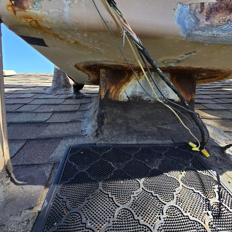 Rust-damaged swamp cooler and roof flashing on shingles Rust-damaged swamp cooler and roof flashing on shingles