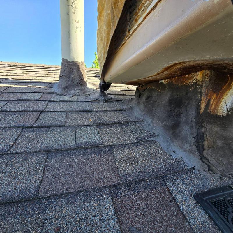 Rusted swamp cooler flashing and shingles on roof Rusted swamp cooler flashing and shingles on roof
